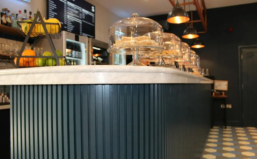 A café counter with glass cake domes