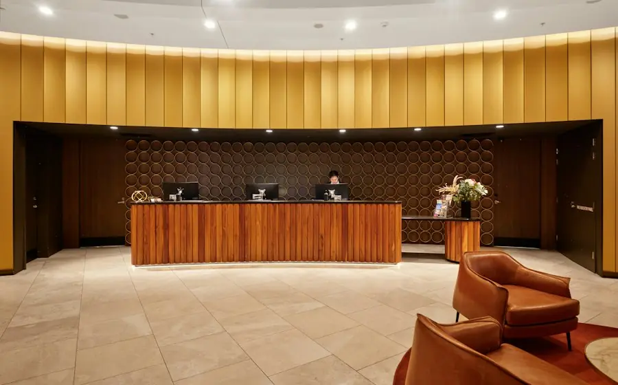 A hotel reception desk in a warm lobby