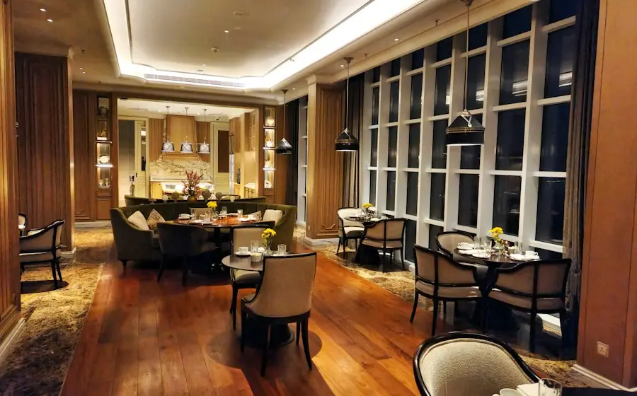 A warm restaurant dining room with wooden tables